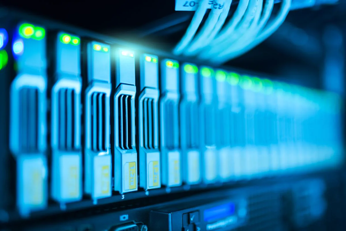 Server rack with glowing blue network indicators in a data center