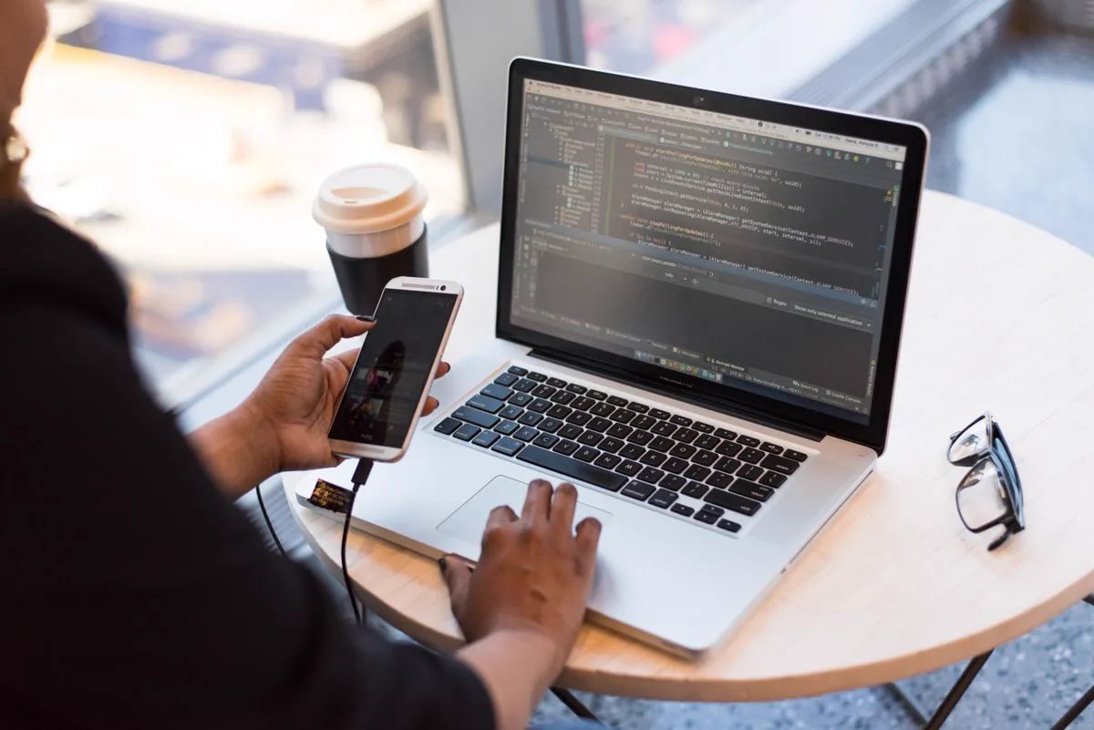 Developer working at a desk with code on screen